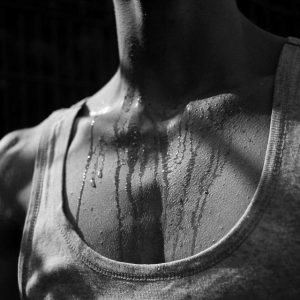 Sweat trickling from the neck and chest