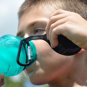 Boy drinking from a plastic bottle