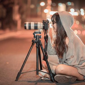 Woman taking photo with the DSLR camera