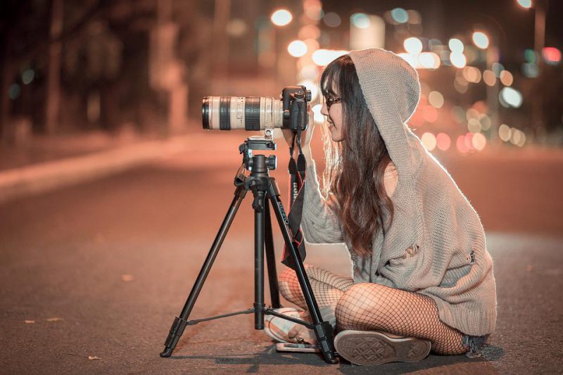 Woman taking photo with the DSLR camera