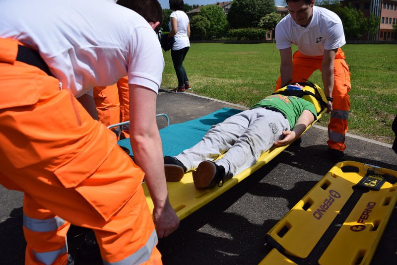 Paramedics carrying a wounded person on a strecher