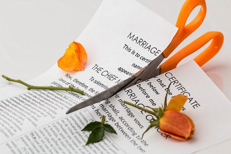 Marriage certificate cut in half with scissors