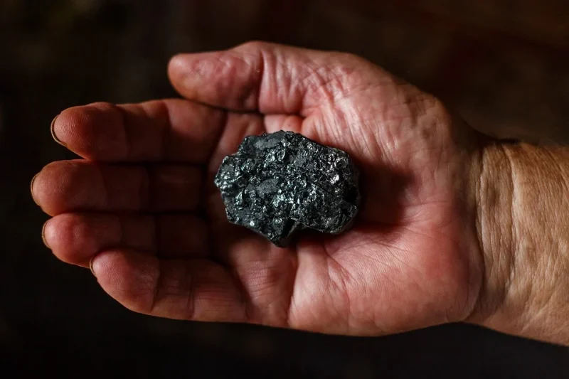 Men holding ore