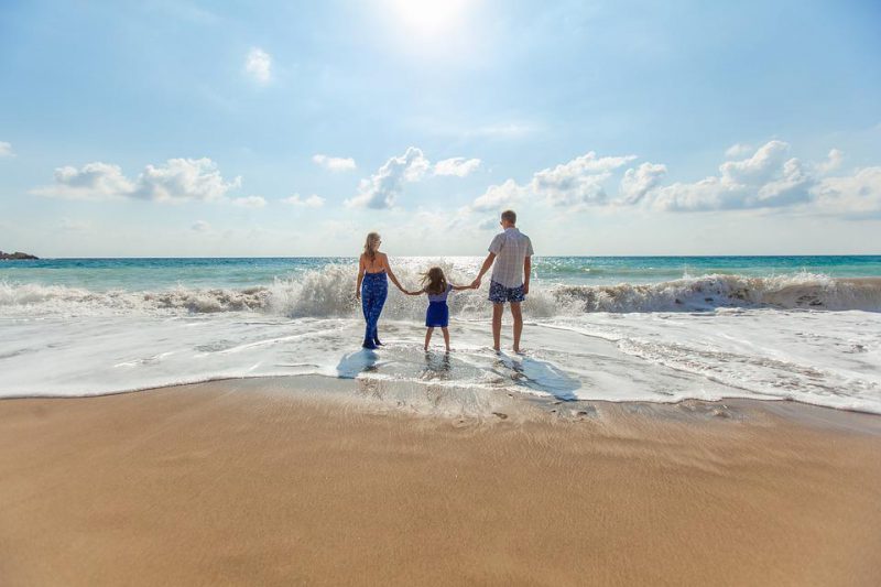 Parents holding hands with a child